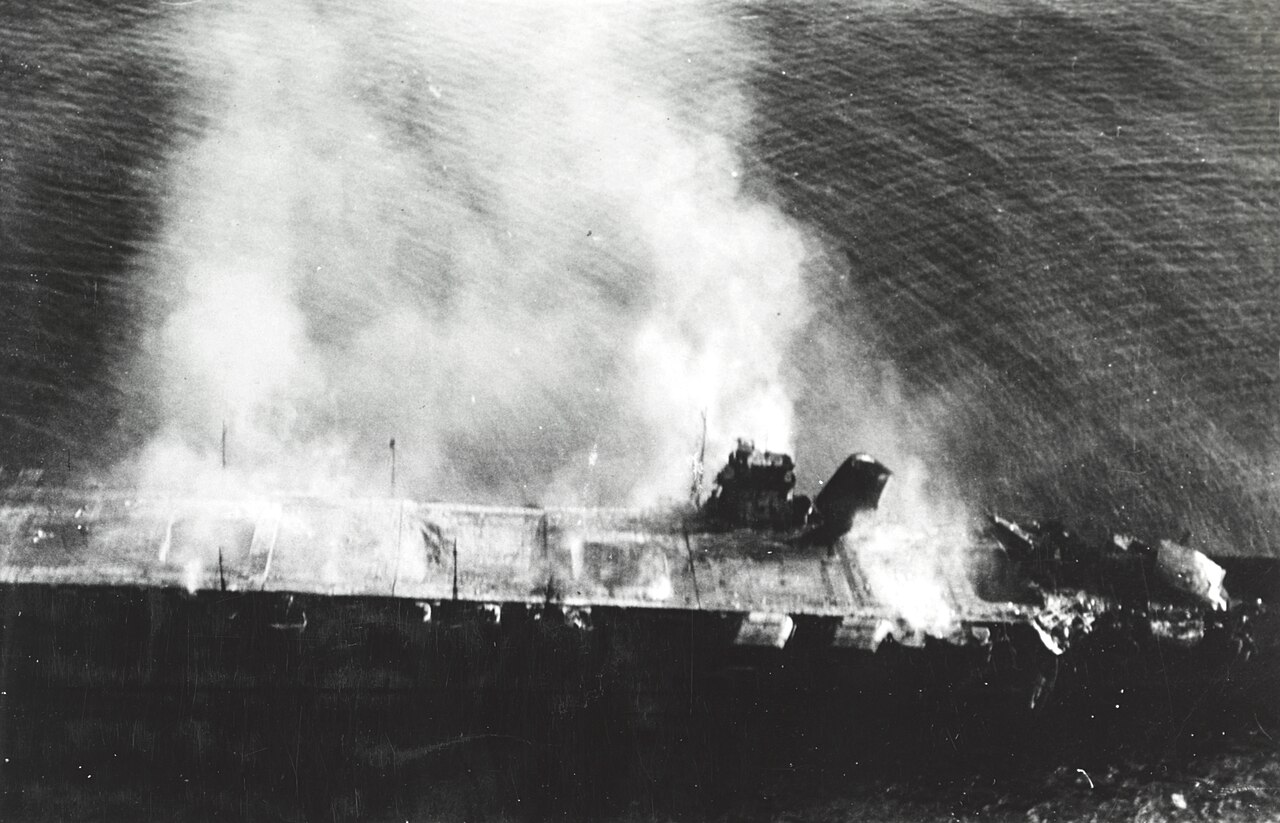 The Japanese aircraft carrier Hiryu burns from stem to stern in the early morning of June 5, 1942, photographed from a Japanese aircraft before she sank.